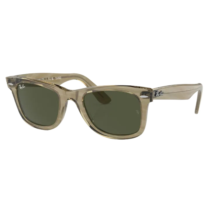 Sunglasses with a beige frame and green lenses on a white background