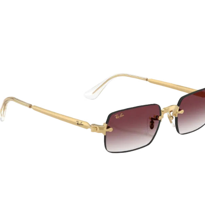 Gold-framed sunglasses with gradient lenses on a white background