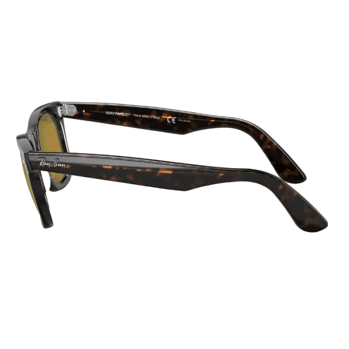 Sunglasses with tortoiseshell frame and gold lenses on a white background