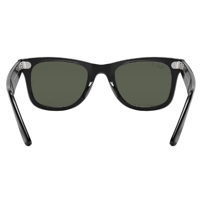 Black sunglasses with green lenses on a white background