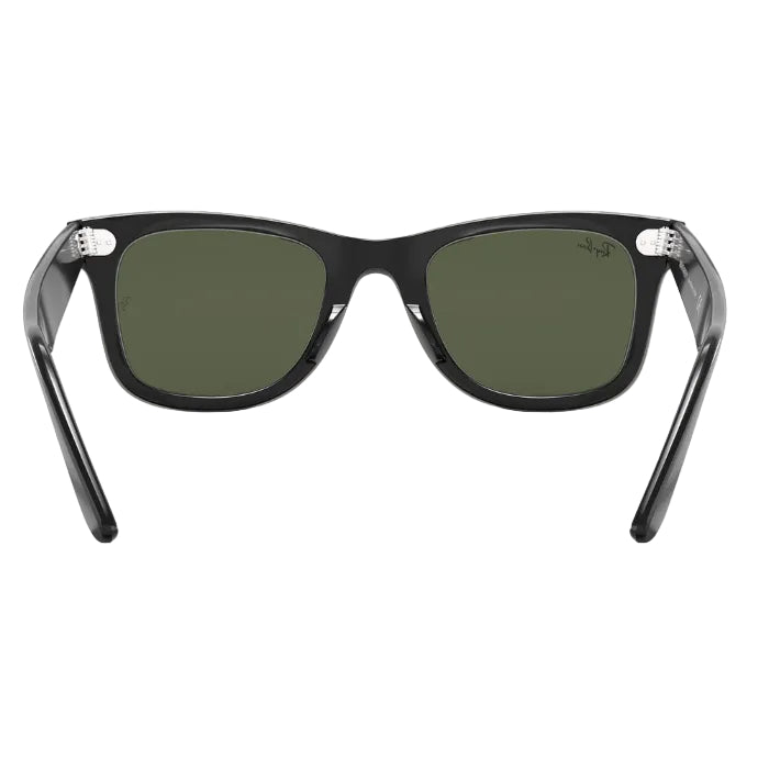 Black sunglasses with green lenses on a white background
