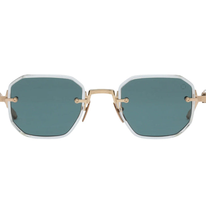 Oversized square sunglasses with muted green lenses, a white translucent frame, and gold metal temples, shown against a plain white background.