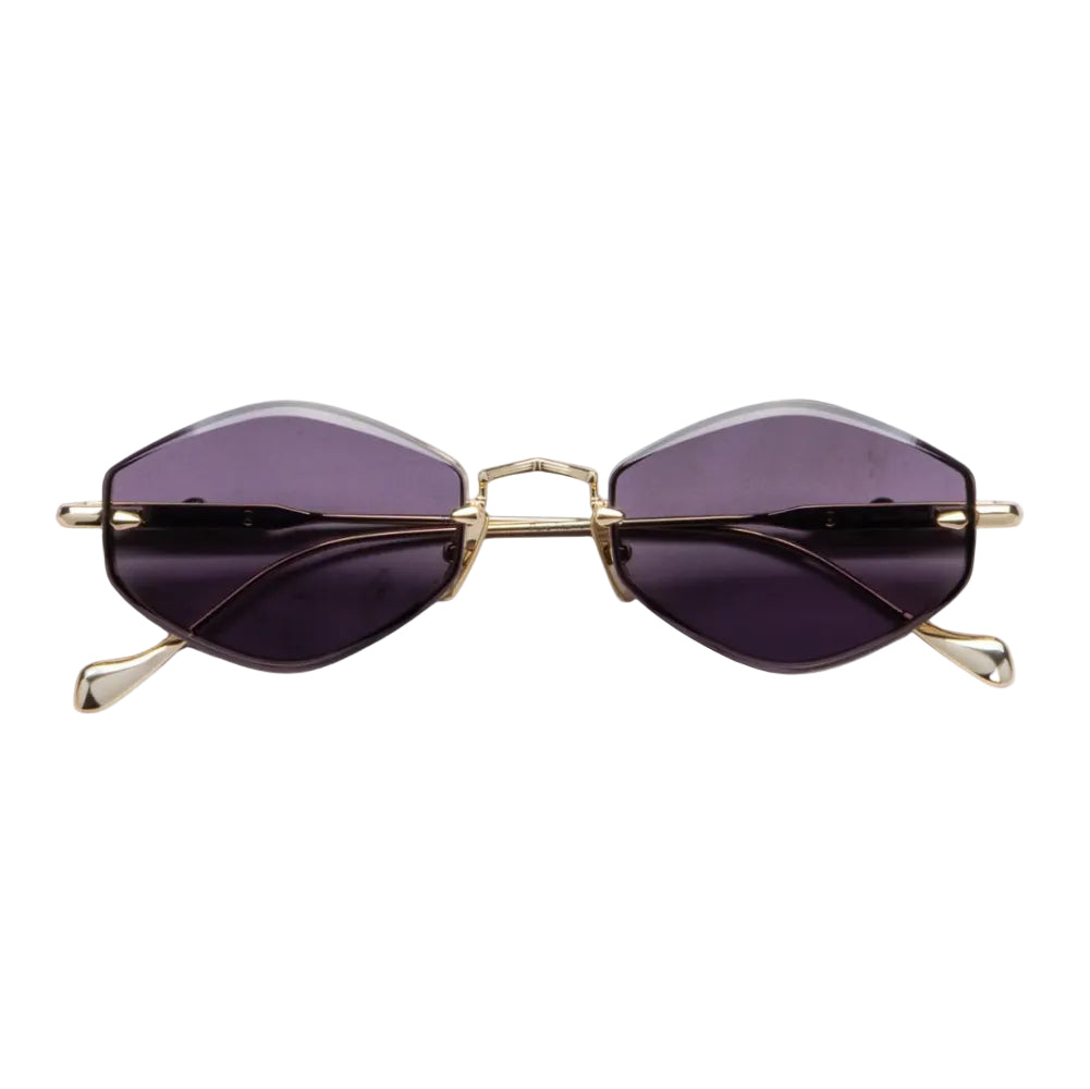 Oversized cat-eye sunglasses with dark purple tinted lenses and a gold metal frame, shown against a plain white background.