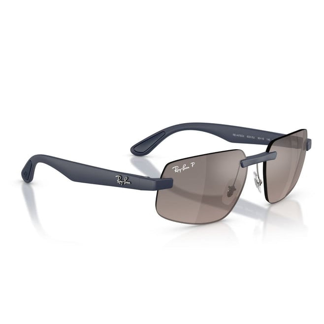 Ray-Ban sunglasses with a matte navy blue frame and brown-tinted lenses, shown on a clean white background with a soft reflection.