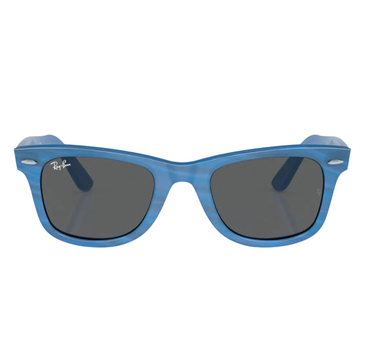 Blue sunglasses with dark lenses on a white background