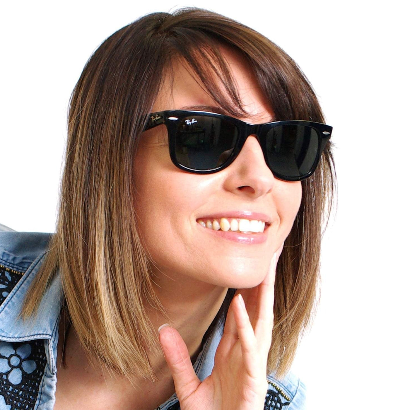 Woman wearing black sunglasses with a blurred background
