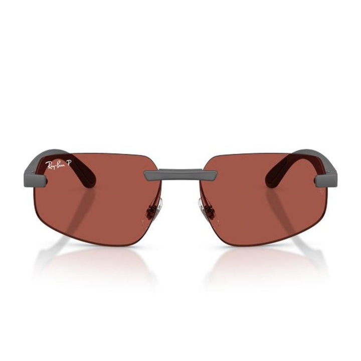 Ray-Ban rimless sunglasses with reddish-brown lenses and a dark gray metal frame, shown on a white background with a soft reflection.